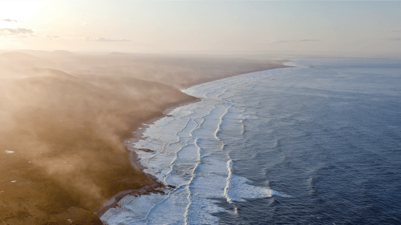 The shoreline of Southern Labrador full of active waves.