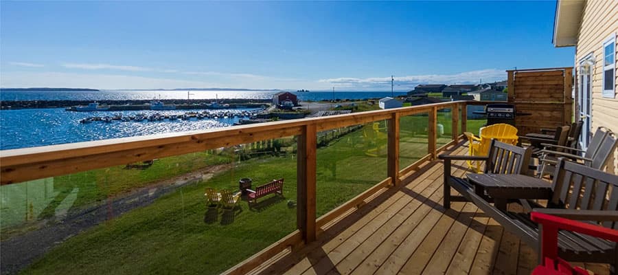 Colorful row houses with blue, yellow, and red exteriors, each featuring white window frames and trim. The street is framed on the sides by the vibrant building facades, with visible overhead utility wires crossing the scene.