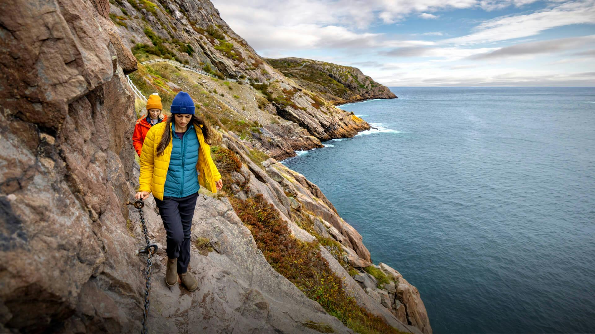 Two travellers are hiking part of the East Coast Trail.