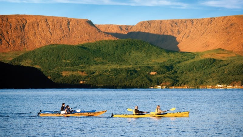 Kayakers are on the water near Gros Morne National Park