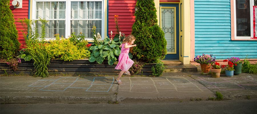 Steep mountain slope with jagged, layered rock formations and patches of greenery. A misty atmosphere covers the peak, creating a dramatic and rugged landscape.
