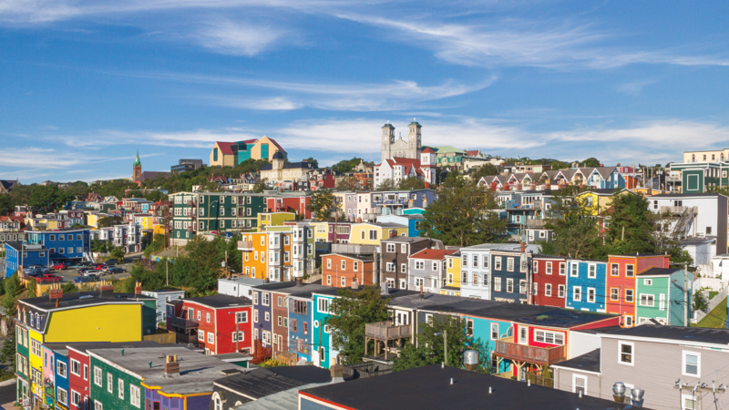 Aerial view of the colourful houses, museums, and cathedrals of St. John’s.