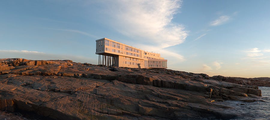 Sunlight is shining on the unique architecture of Fogo Island Inn.