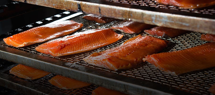 Fillets of smoked salmon cooking on the smoker.