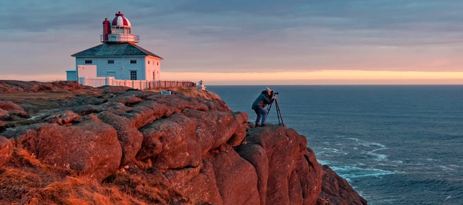 A photographer is capturing the first sunrise in North America at Cape Spear Lighthouse.